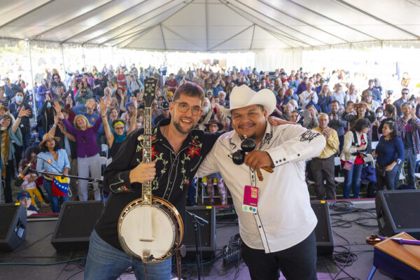 Joe Troop and Larry Bellorin pose in front of a huge Richmond Folk Festival crowd giving them a standing ovation.