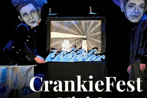 This image depicts two performers with a crankie (a scrolled panorama light box) in between them and has the words "CrankieFesr Mini Grants" in bold lettering.